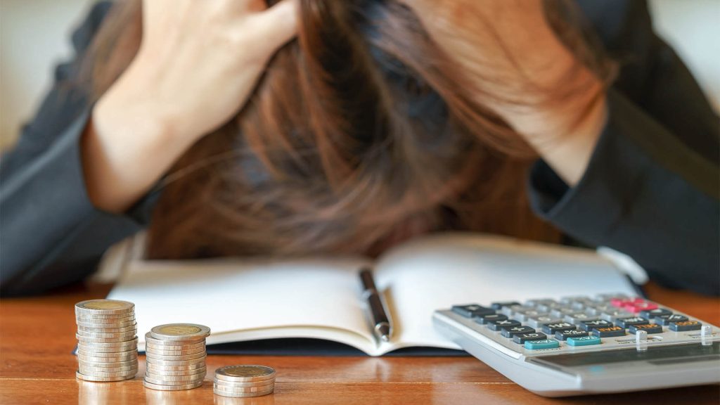 A common financial mistake: living paycheck to paycheck, leading to debt pressure and stress.