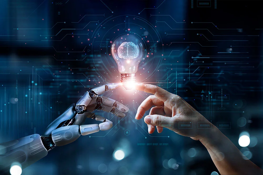 Robotic hand and human hand reaching toward a glowing lightbulb over a circuit background
